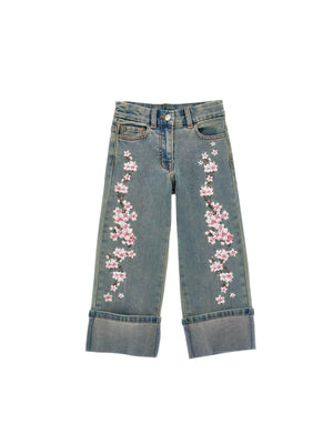 Jeans bambina ricamati con fiori e risvolto alto
