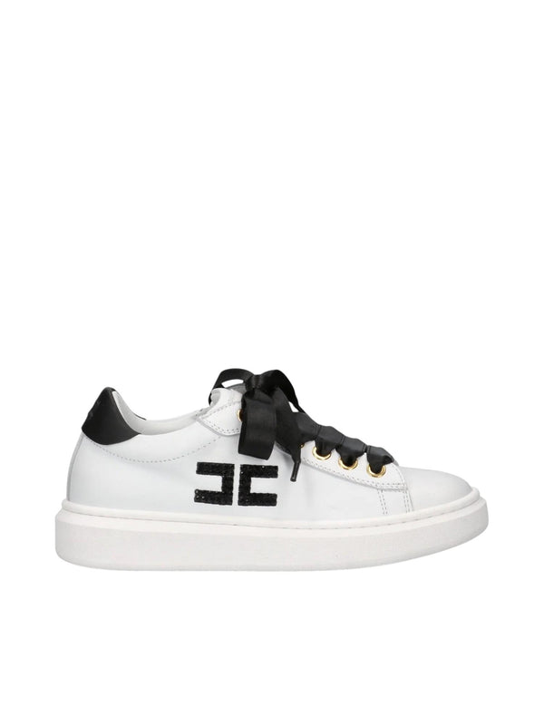 Sneakers bambina in pelle bianca e nera con fiocchi