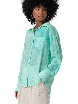 Camicia donna turchese in tessuto lucido stampato