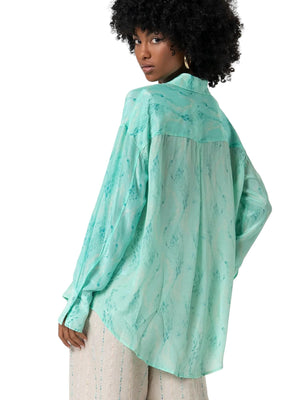 Camicia donna turchese in tessuto lucido stampato