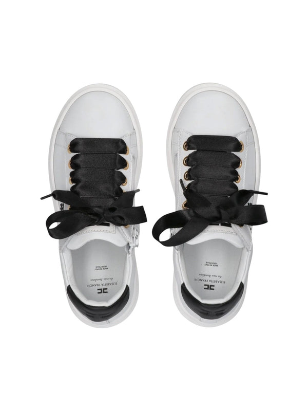 Sneakers bambina in pelle bianca e nera con fiocchi